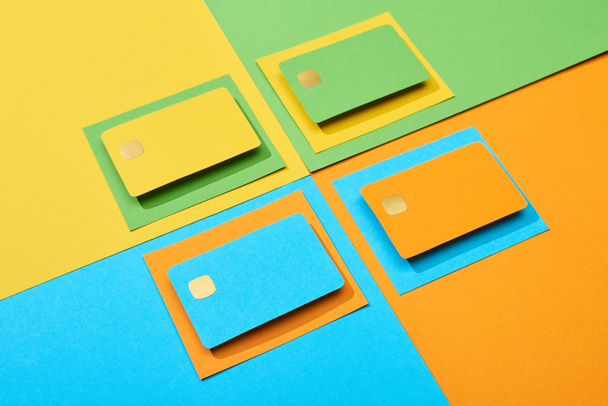 empty credit cards on green, orange, blue and yellow background - Foto, Imagen