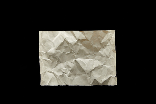top view of empty crumpled vintage paper isolated on black - Foto, immagini