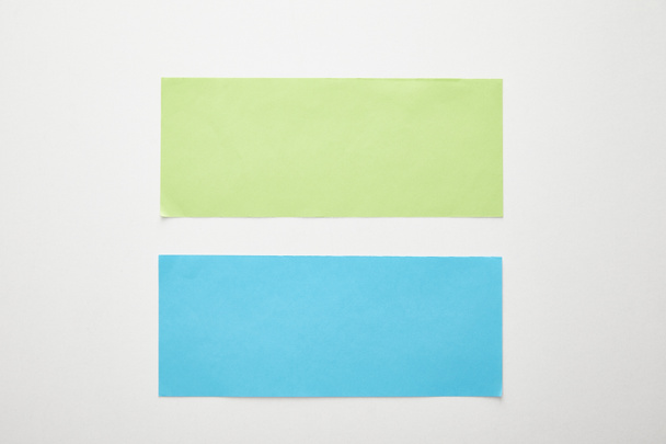 top view of empty blue and green paper on white background - Φωτογραφία, εικόνα