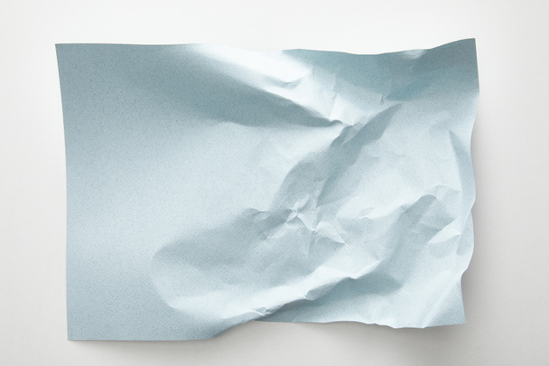 top view of empty crumpled blue paper on white background - Fotoğraf, Görsel