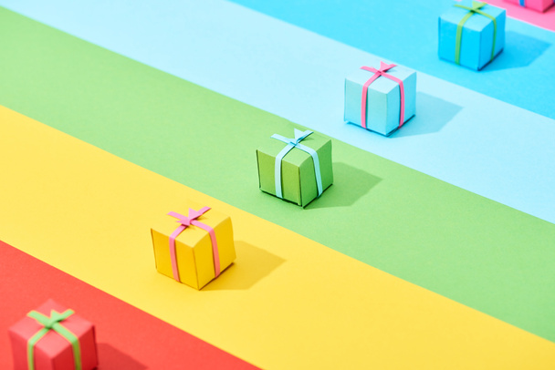 multicolored gift boxes on rainbow background - 写真・画像