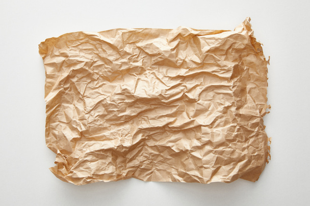top view of empty crumpled craft paper on white background - Photo, Image