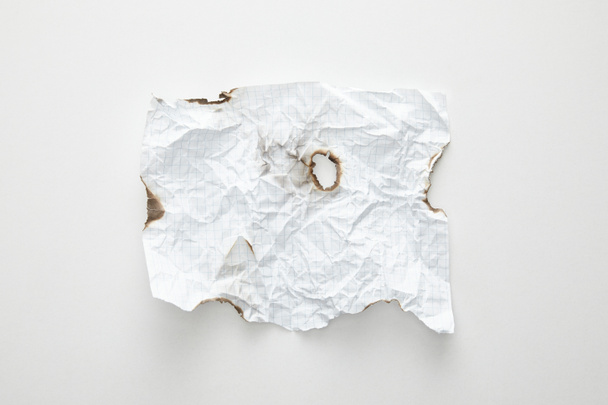 top view of empty crumpled and burnt vintage paper on white background - Photo, Image