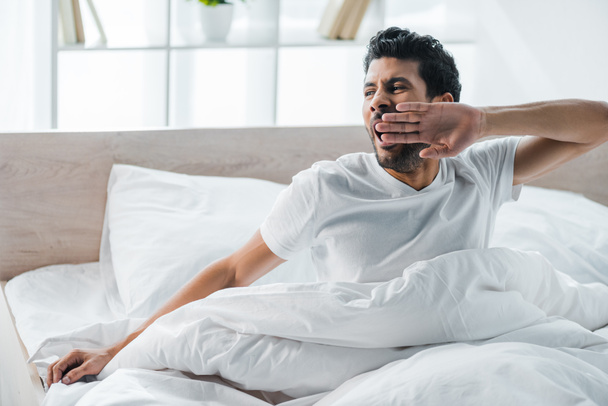 handsome bi-racial man yawning and waking up in morning  - Photo, Image