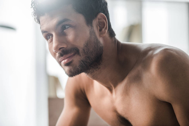 handsome and sexy bi-racial man smiling and looking away in morning  - Foto, Imagem