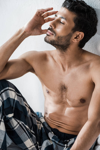 handsome and pensive bi-racial man with closed eyes in morning  - Valokuva, kuva