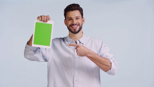 man pointing with finger at digital tablet isolated on blue  - Footage, Video