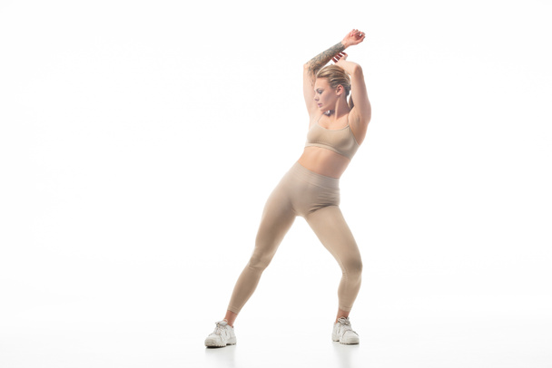 twerk girl in beige leggings posing isolated on white - Fotoğraf, Görsel