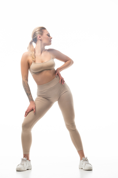 twerk girl in beige leggings posing isolated on white - Zdjęcie, obraz