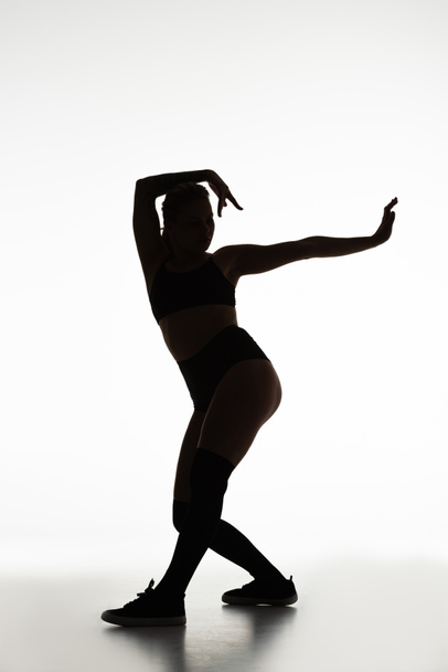 silhouette of sexy girl twerking isolated on white - Foto, imagen