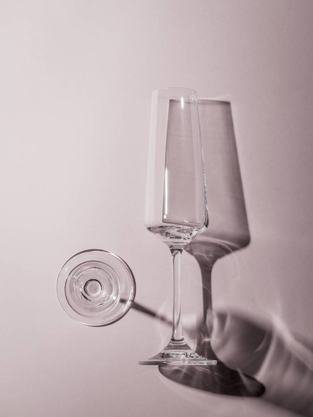 Monochrome image of two glass glasses in hard light. - Photo, Image