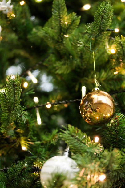 Christmas tree decorated with golden shiny baubles - Foto, afbeelding