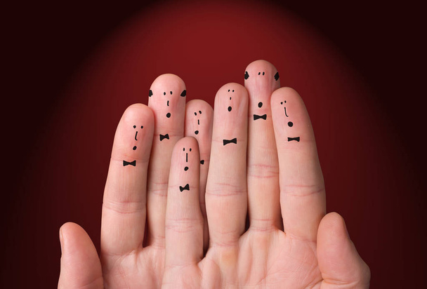 Faces are painted on the fingers. Choir singing together. Cheerful fingers depict a classic choir - Фото, зображення