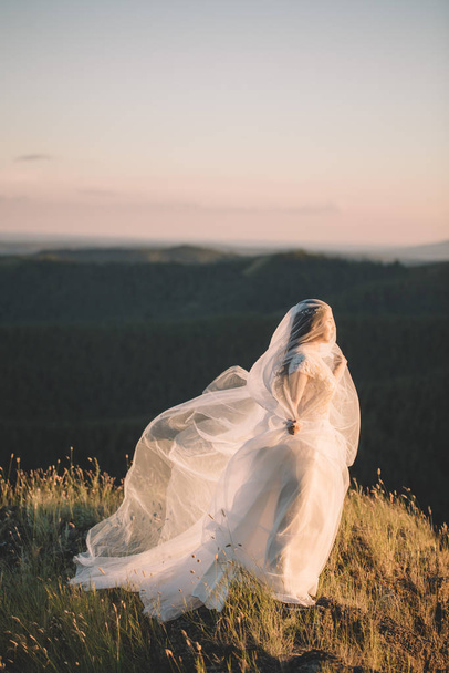 Beautiful bride outdoors in a forest. - Фото, изображение