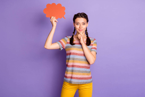 Photo of pretty lady holding red mind cloud showing banner text think over creative advert wear casual striped t-shirt yellow trousers isolated purple color background - Photo, Image