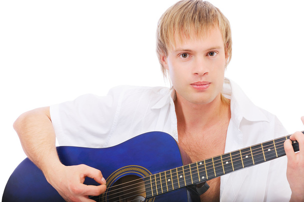 Beautiful young man plays guitar - Φωτογραφία, εικόνα