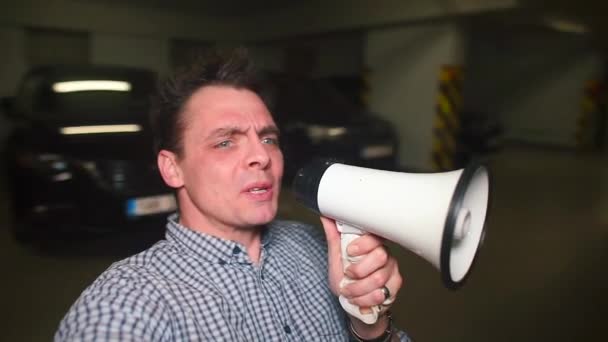Video blogger shouts into a megaphone. - Materiał filmowy, wideo