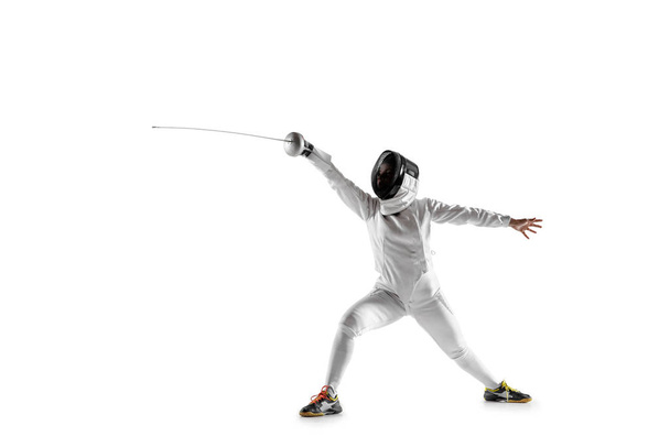 Teen girl in fencing costume with sword in hand isolated on white background - Фото, изображение