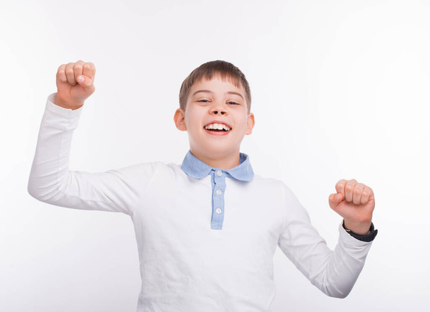 Young boy smiling and celebrating over white background - Photo, image