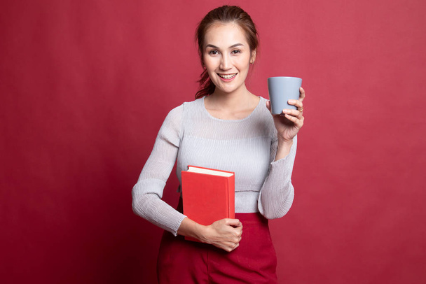 Young Asian woman with a book and cup of coffee. - Photo, image