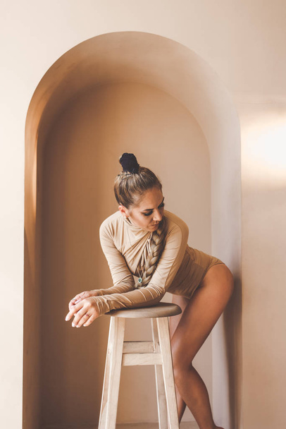 Elegant woman dancer in sexy lingerie posing in the studio. Lady does strip plastic. Flexible girl demonstrates her body in various poses - Φωτογραφία, εικόνα