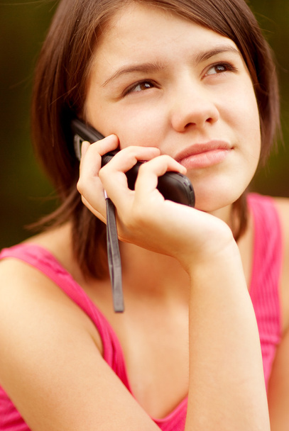 Beautiful young woman talking on cell phone - 写真・画像