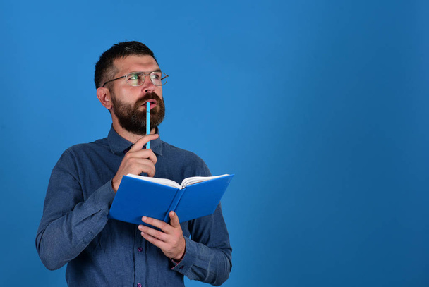 Man with beard and book. Idea and knowledge concept - Фото, изображение