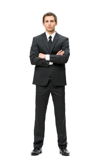 Full-length portrait of businessman with hands crossed - Foto, afbeelding