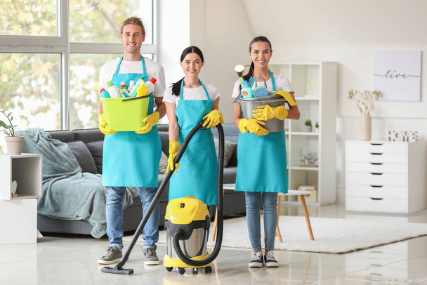 Equipe de zeladores com suprimentos de limpeza em apartamento
 - Foto, Imagem