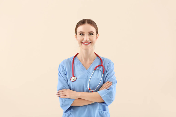 Portrait of female doctor on light background - Zdjęcie, obraz