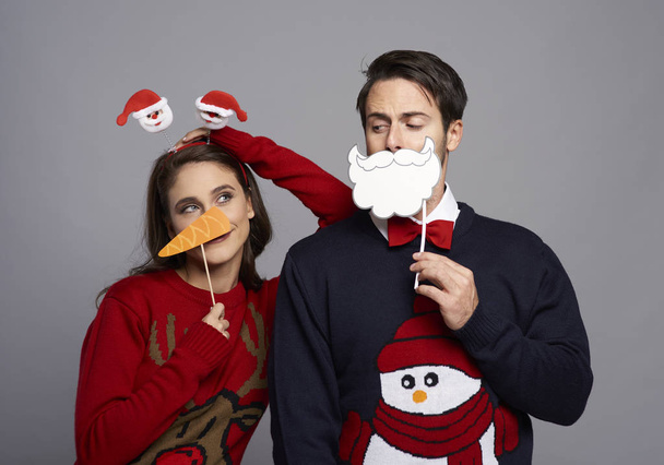 Boyfriend and girlfriend with Christmas masks - 写真・画像