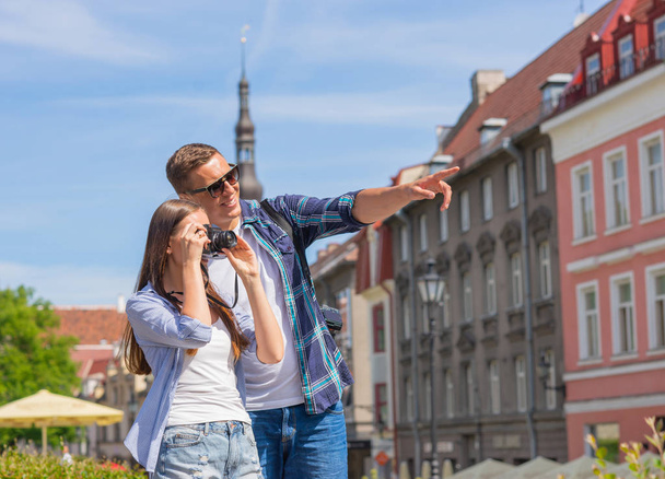Couple of tourists traveling and exploring beautiful old town together. Loving man and woman in a vacation trip concept. - Foto, immagini