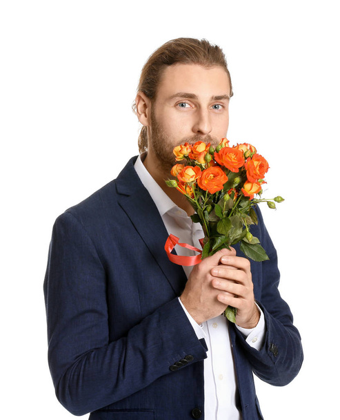 Handsome man with flowers on white background. Valentine's Day celebration - Foto, Imagen