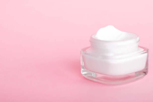 Face cream moisturizer jar on pink background, moisturizing skin - Photo, Image