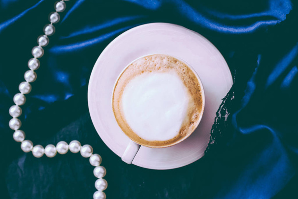 Cup of cappuccino for breakfast with satin and pearls jewellery  - Photo, Image