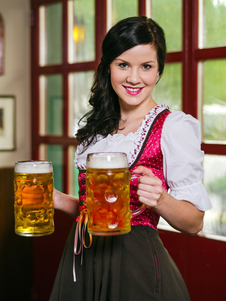Beautiful Oktoberfest waitress with beer - Fotó, kép