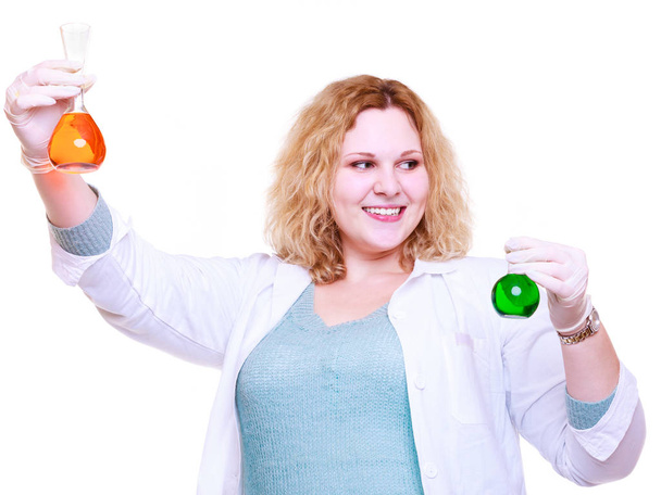 Chemist woman holds test flasks - Foto, afbeelding