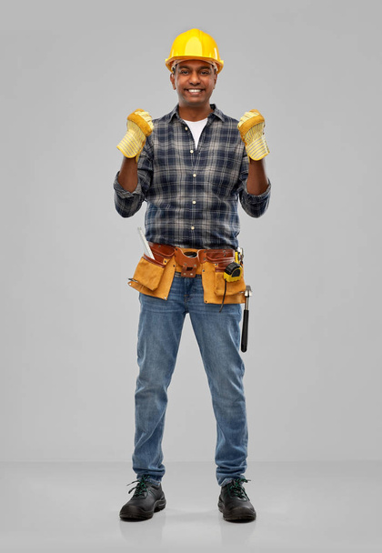 indian worker or builder in helmet and gloves - Foto, afbeelding