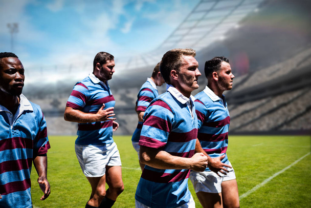 Rugby players against rugby stadium - Фото, изображение