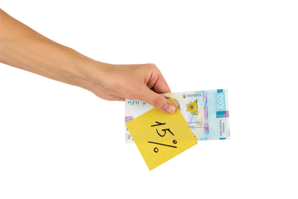 Thousand hryvnias and sticker with different financial signs and symbols in the hand, isolated - Foto, afbeelding