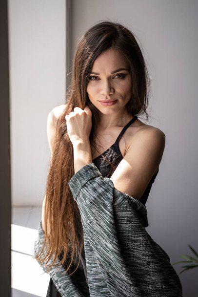 Woman in black tank top and gray cardigan - Photo, image