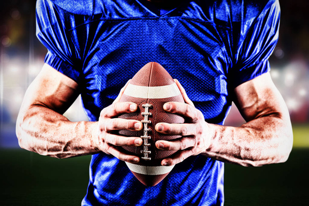 American football player against view of a blurred sports arena - Фото, изображение