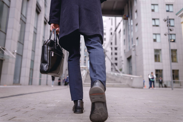 Low angle photo of man that going to his work - 写真・画像