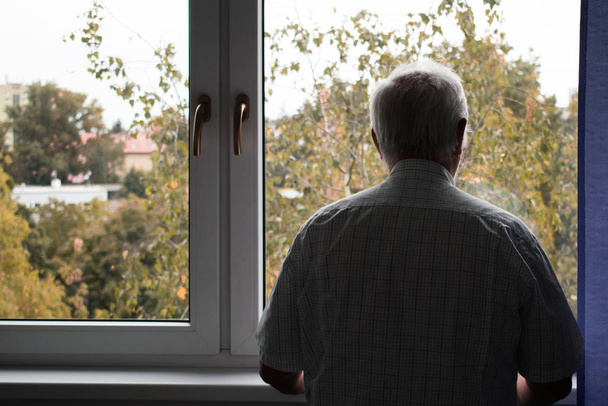 сумний старший чоловік стоїть один вдома всередині крупним планом пригнічений
  - Фото, зображення