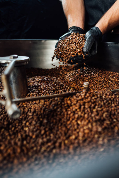 worker took Freshly roasted coffee to check the quality of mixer - 写真・画像