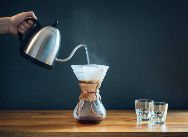making coffee by an alternative method, pouring hot water from a - Foto, Imagem