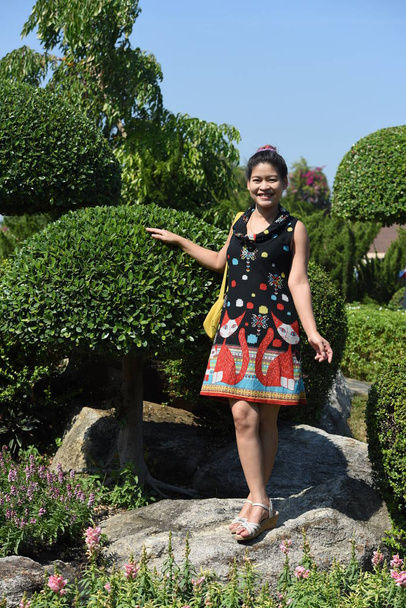 young asian woman posing in floral park with colorful flowers at daytime   - Photo, Image