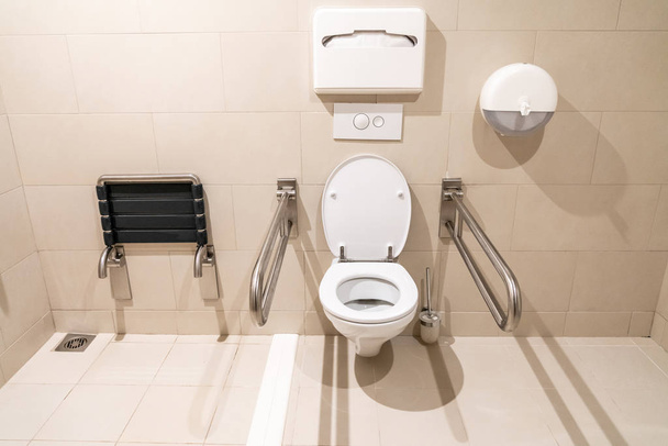 Banheiro público para pessoas com deficiência com equipamento especial
 - Foto, Imagem
