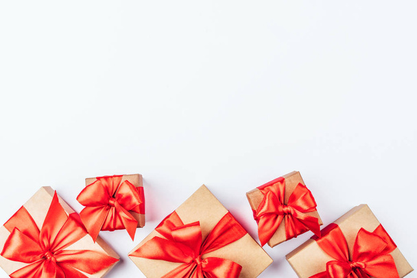 Frame of cardboard gift boxes with red bows. - Photo, image