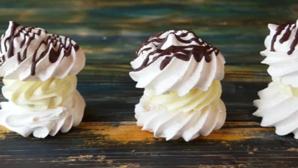 White sweets with cream on wooden background. - Footage, Video